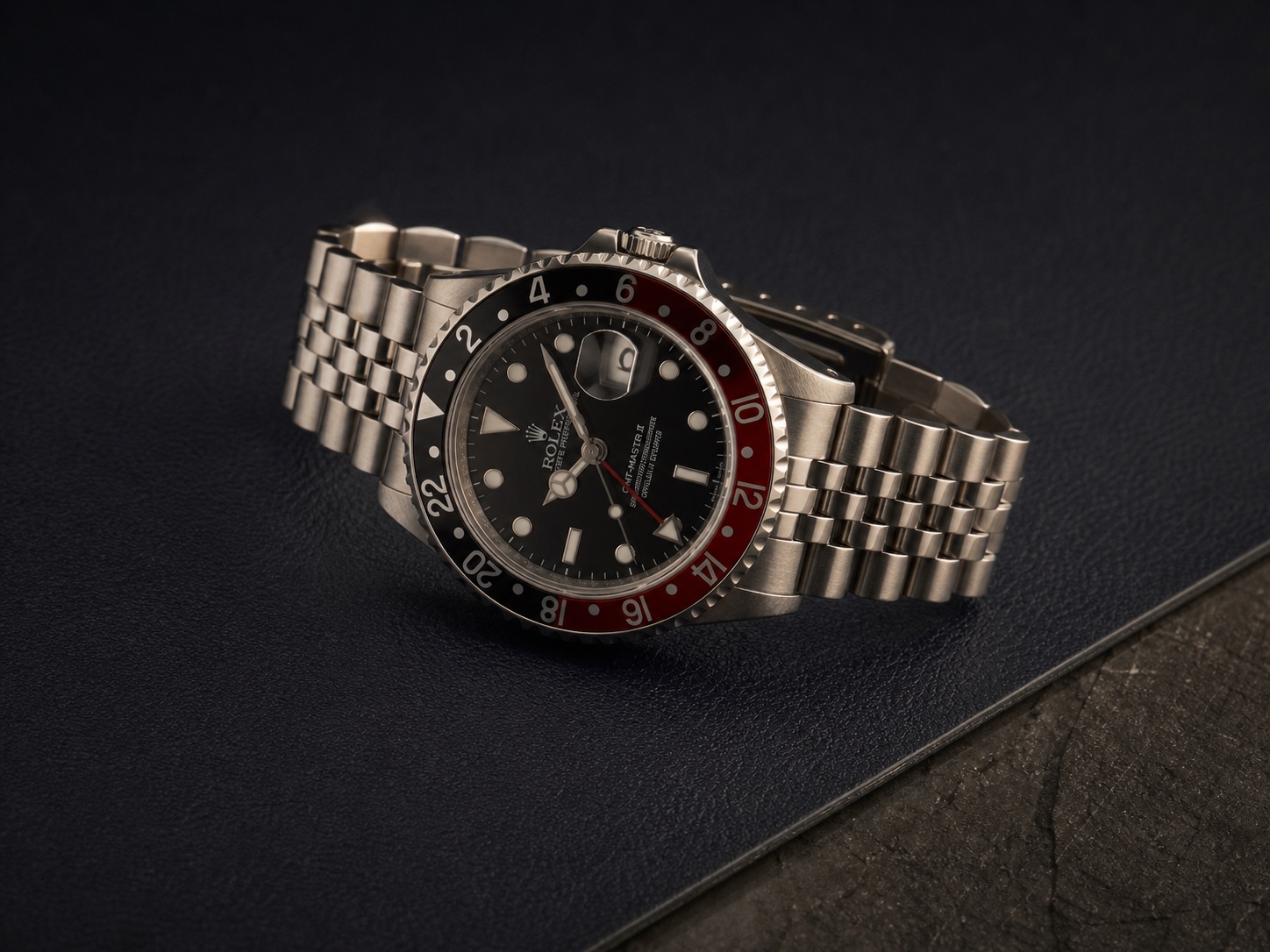 Vintage red and black bezel GMT-style watch on a Jubilee bracelet
