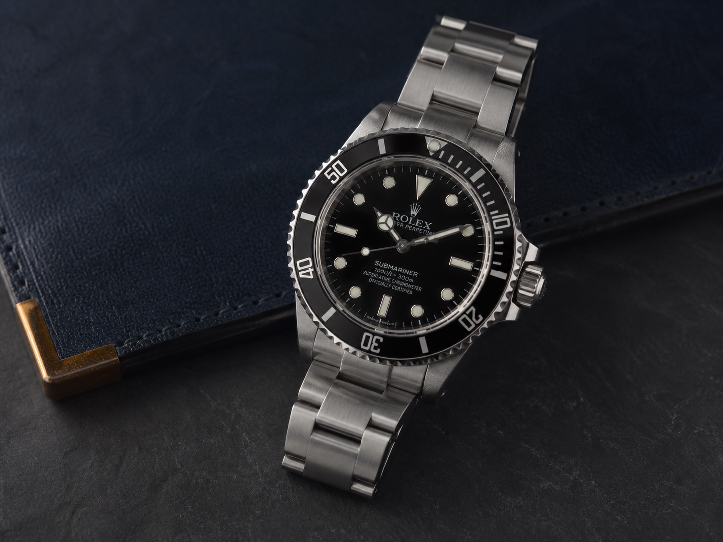 Pre-owned black Submariner-style no-date watch on navy leather